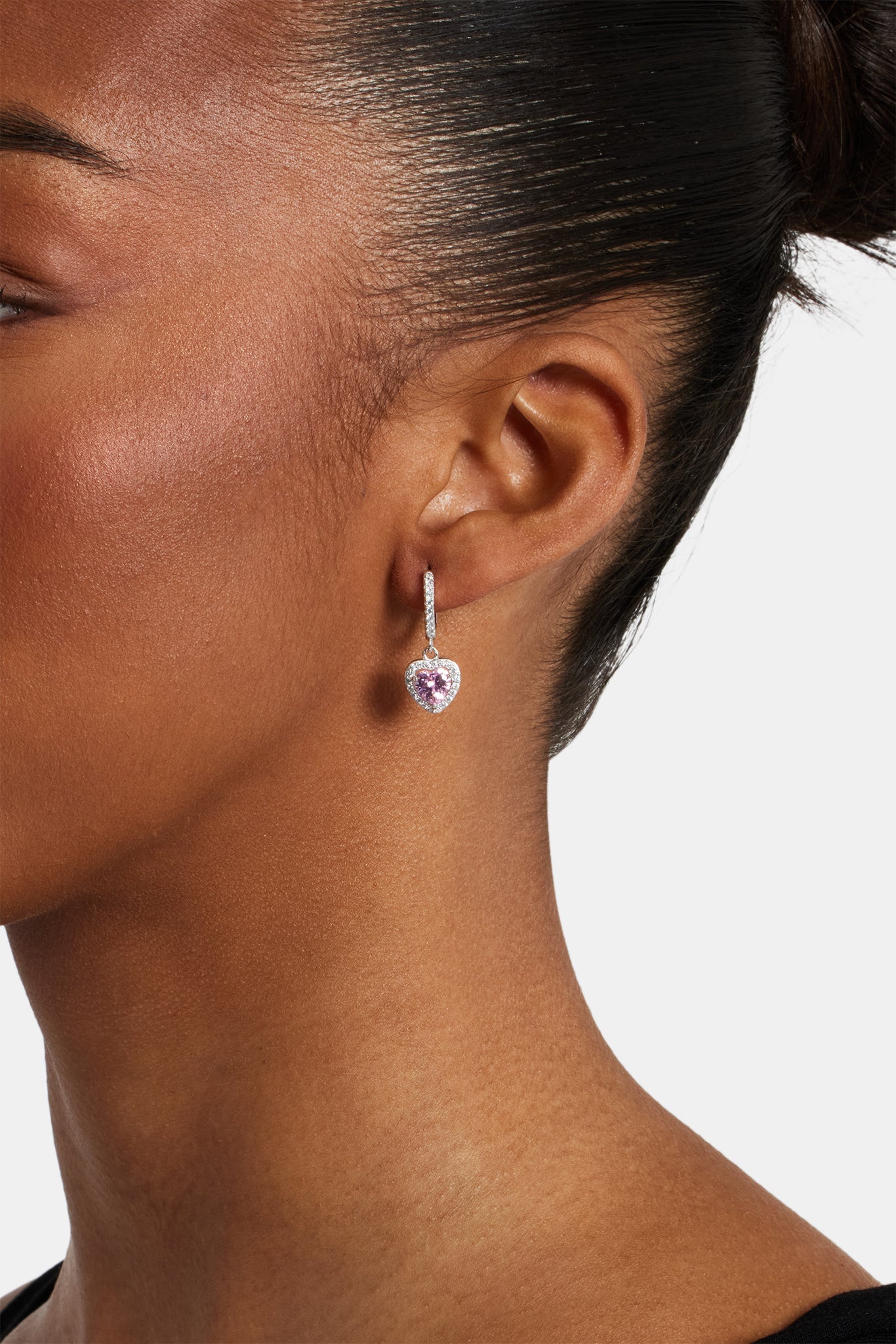 female model wearing pink heart drop earrings